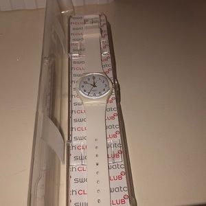 White with white and gold face Swatch watch